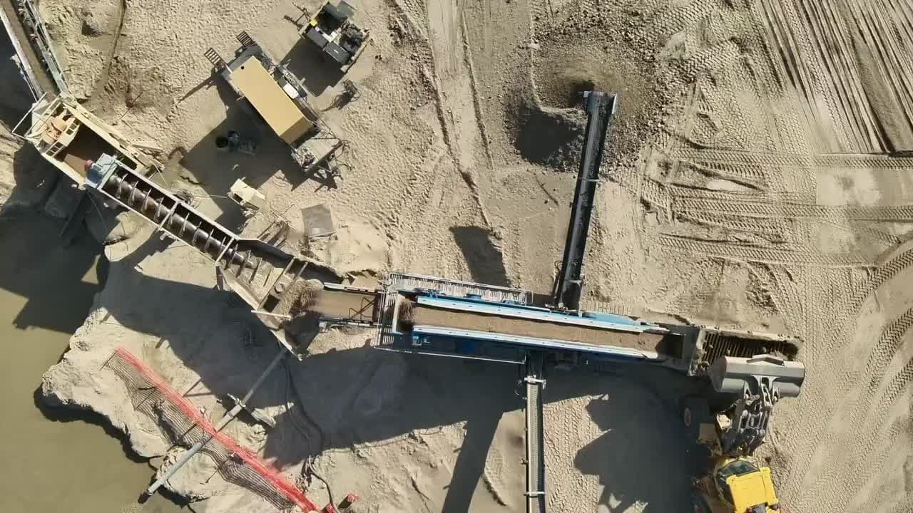 Aerial view of quarry operations with conveyors and material stockpiles